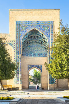 Gur-e-Amir mausoleum entrance portal with intricate blue tilework and muqarnas vaulting in Samarkand Uzbekistan. Ideal for travel publications, cultural heritage materials, and architectural studies.