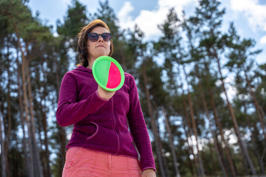Woman Holding Paddle Ball Game Equipment On Beach During Summer Outdoor Recreation And Play