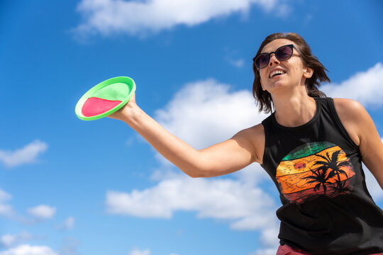 Happy Woman Playing Paddle Ball On Beach During Summer Vacation Outdoor Sport And Recreation