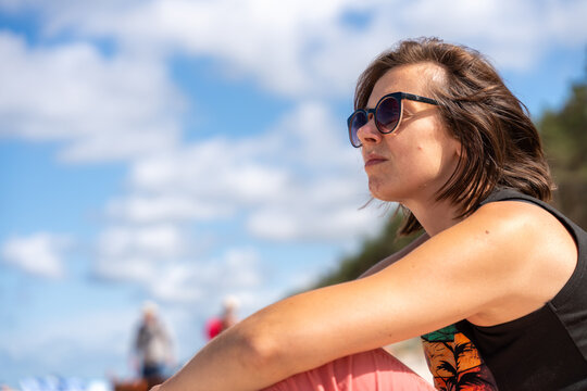 Woman Relaxing On Beach In Sunglasses During Sunny Summer Vacation And Coastal Leisure