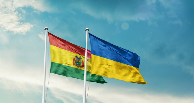 Bolivia and Ukraine friendship flags are waving in the sky. Two country flag for agreement or deal. Bolivia Ukraine national flag for commitment.
