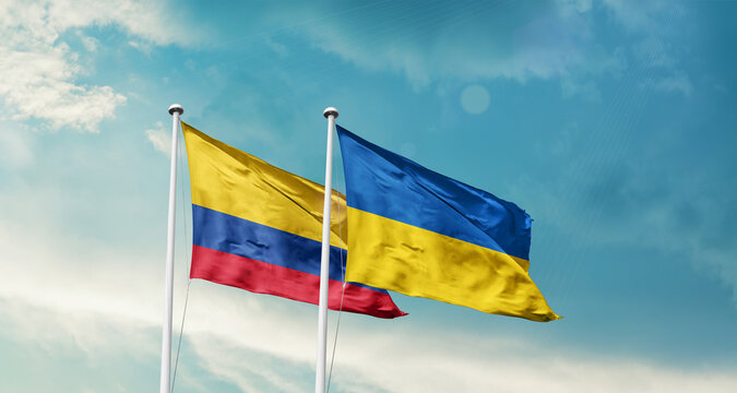 Colombia and Ukraine friendship flags are waving in the sky. Two country flag for agreement or deal. Colombia Ukraine national flag for commitment.