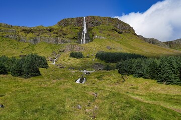 Bjarnarfoss is a majestic 80-meter two-tiered waterfall cascading over dark basalt columns on the southern coast of Iceland's Snafellsnes Peninsula. © Mariusz