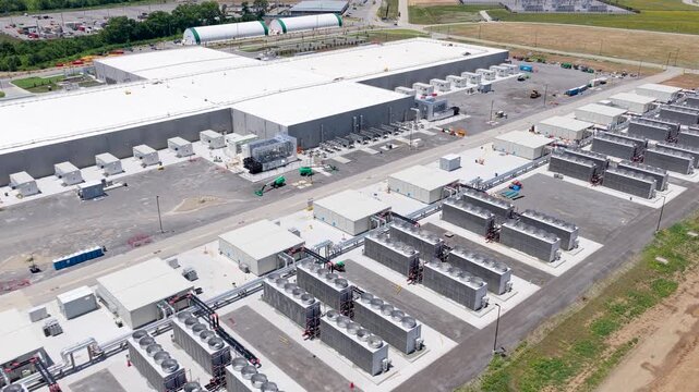 Meta's massive data center campus in Gallatin, large server building with extensive rows of industrial cooling equipment, aerial tracking view