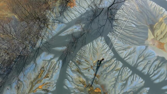  Flying over contaminated mine waters in decanting pond aerial view. Environmental pollution