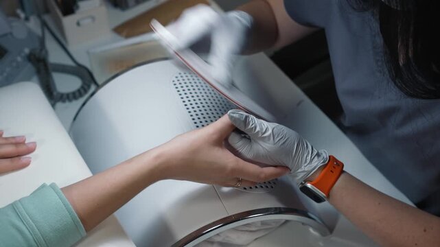 Nail shape filing with file during manicure in beauty salon with professional and careful execution