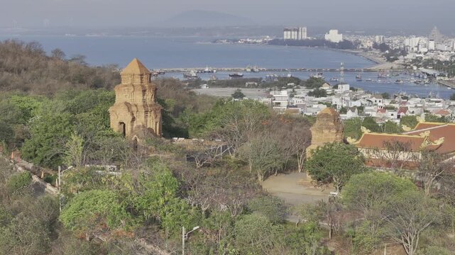 Aerial drone view of Po Sah Inu Cham Towers at sunrise in Phu Thuy, Lam Dong, Vietnam, highlighting ancient Cham architecture and cultural heritage in the morning light.