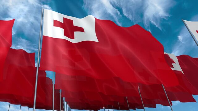 Multiple Tonga flags seamless looping waving on blue sky