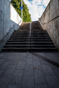 Wide Stone Staircase Leads from a Shaded Underground Passage