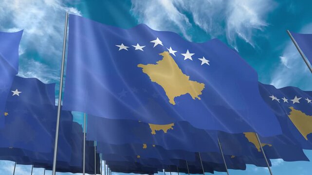 Multiple Kosovo flags seamless looping waving on blue sky