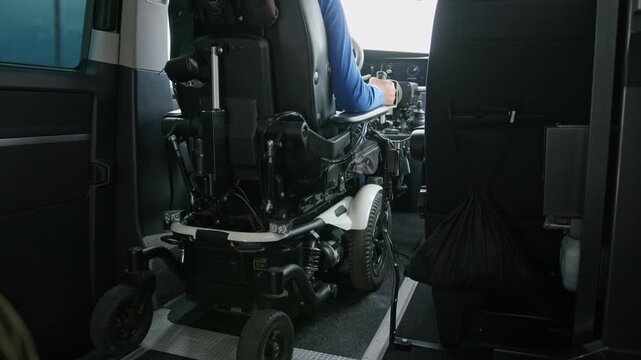 Wheelchair user driving an accessible vehicle, a van with assistive technology supporting mobility and transportation independence
