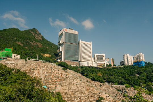 Chinese Christian Cemetery in Pok Fu Lam with Queen Mary Hospital visible in the background on Hong Kong Island, Hong Kong - 27 August 2026.