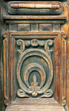 Vintage carved wooden door handle detail and ornament