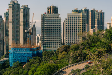 Naklejka premium High-rise residential buildings and an active construction site in the Mid-Levels district on Hong Kong Island, showcasing the city’s dense urban development and rapidly changing skyline - 27 August 2