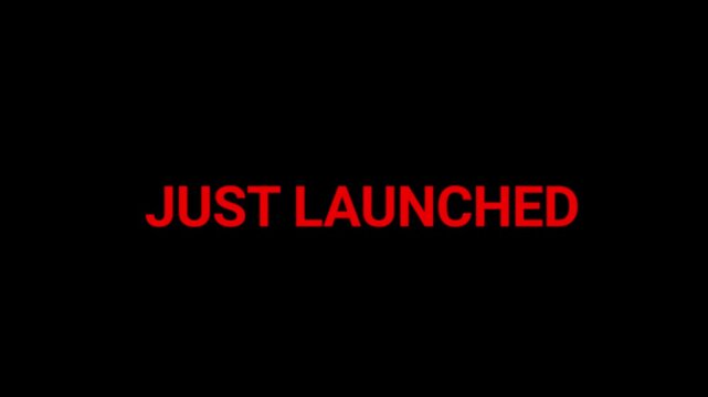 Text sign saying just launched appears in bold red letters against a deep black background for product release marketing announcements.