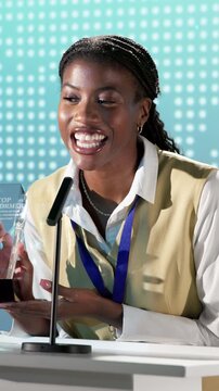 Black woman, speech and award on podium at seminar, nomination and thank you for top performer. Smile, person and speaker at conference with trophy, corporate excellence and outstanding performance