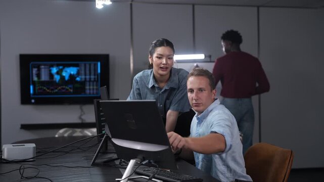 Software developer team programming and coding on computer screen in modern IT office, Diverse male and female collaboration, technology business startup, teamwork and future digital innovations