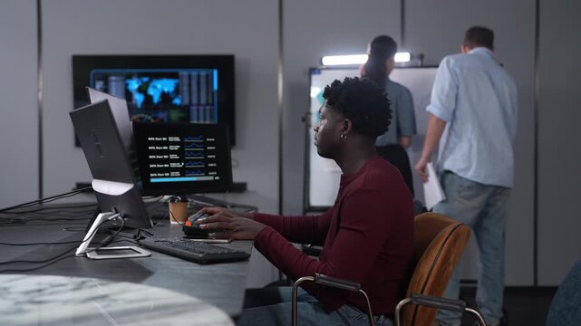 African male programmer coding on computer monitors in modern technology office, Software development, IT business startup, professional software engineer working on smart future digital innovations