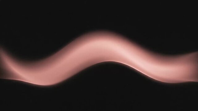 Abstract flowing light and smoke trails captured in dynamic video sequence showing movement and fluidity in dark environment