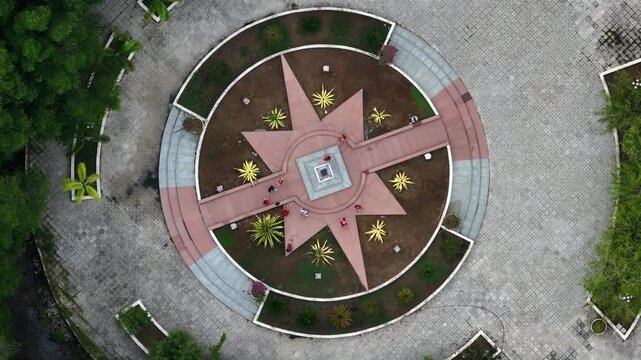 Aerial drone view of Mui Ca Mau National Park in Dat Mui, Ca Mau, Vietnam, featuring the national flagpole and coordinate marker surrounded by sunlit mangrove forests.