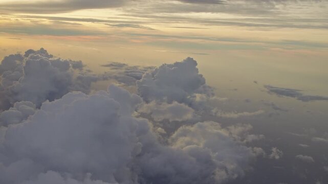 Towering Clouds Glowing Beneath Golden Sunset Sky