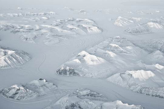 Aerial view of a remote dramatic Snowy mountain landscape, Greenland