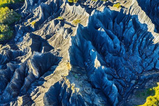 Dramatic aerial view of black stone forest landform with sharp eroded ridges in Sichuan, China.