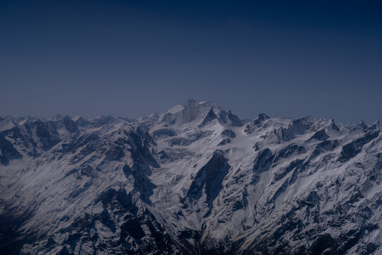 Aerial view of Nanga Parbat with snow-covered peaks and rugged mountain ridges in Gilgit, Pakistan.