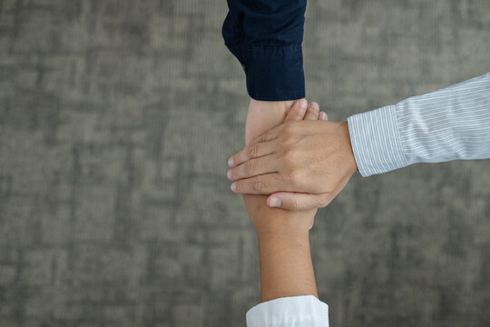 Business team stacking hands together for unity teamwork collaboration support and corporate success connection concept with copy space