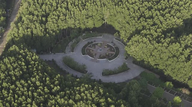 Aerial drone view of Mui Ca Mau National Park in Dat Mui, Ca Mau, Vietnam, featuring the national flagpole and coordinate marker surrounded by sunlit mangrove forests.