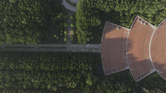Aerial drone view of Mui Ca Mau National Park in Dat Mui, Ca Mau, Vietnam, featuring the national flagpole and coordinate marker surrounded by sunlit mangrove forests.