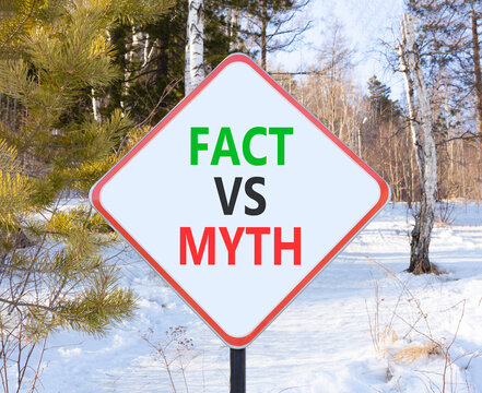 Fact vs versus myth words symbol. Concept words Fact vs Myth on beautiful white road sign. Beautiful winter forest background. Business and fact vs versus myth concept. Copy space.