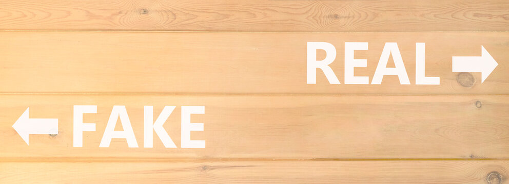 Real or fake words symbol. Concept words Fake and Real on beautiful wooden wall. Beautiful wooden wall background. Business and real or fake concept. Copy space.