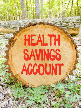 Health saving account symbol. Concept words Health saving account on beautiful wooden circle. Beautiful green forest background. Medical Health saving account concept. Copy space.