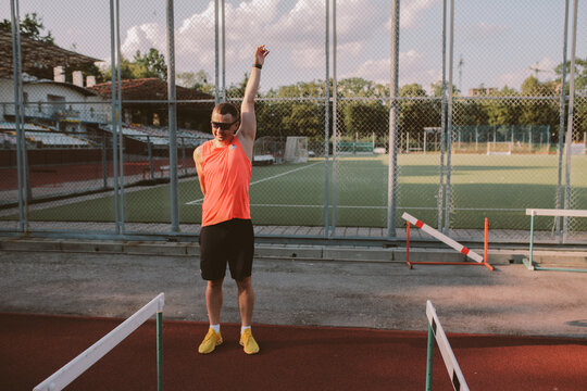 Male athlete training alone at outdoor sports stadium