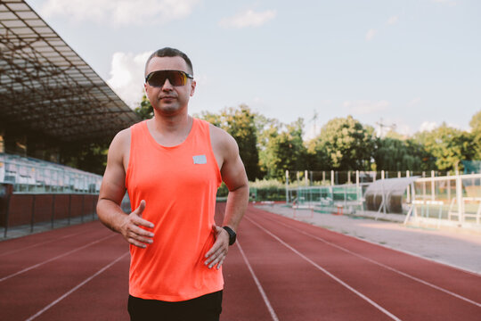 Male athlete training alone at outdoor sports stadium
