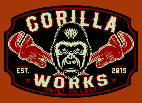 Retro industrial workshop emblem featuring a fierce gorilla head centered between two crossed pipe wrenches in red and black