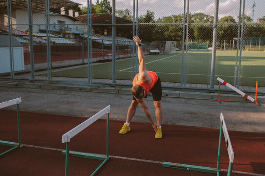 Male athlete training alone at outdoor sports stadium