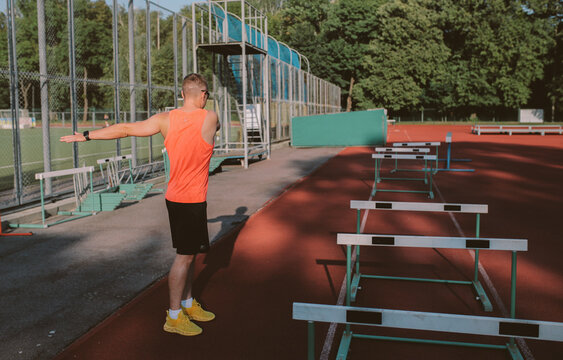 Male athlete training alone at outdoor sports stadium