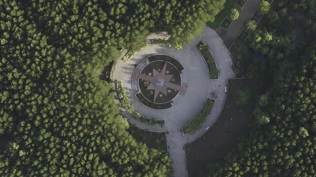Aerial drone view of Mui Ca Mau National Park in Dat Mui, Ca Mau, Vietnam, featuring the national flagpole and coordinate marker surrounded by sunlit mangrove forests.