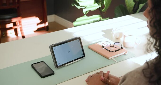 African-American woman sitting at desk on mint mat using tablet while sunlight shifting, copy space