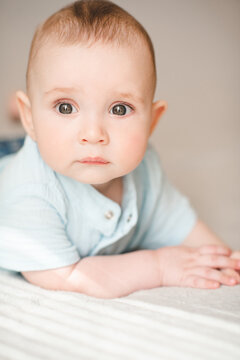 Cute baby boy crawling in bed close up. Good morning. Babyhood.