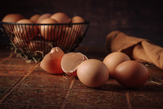 Fresh brown eggs in a basket ready for baking and cooking on a rustic tiled surface