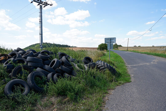 Illegal used car tyre dumping site near road, Czechia