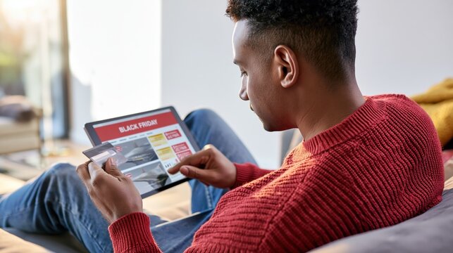Man is relaxing at home and shopping electronics online during Black Friday sale