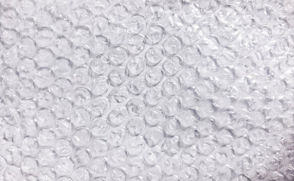 Close-up of clear bubble wrap plastic texture on white background. Bubble wrap plastic texture background for packaging, shipping, and design