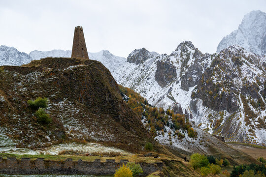 Watchtower in the village of Sioni (Khev Gorge, Kazbegi Municipality, Georgia) against the backdrop of the snow-capped peaks of the Greater Caucasus.