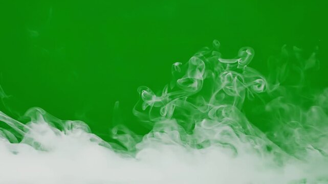 White smoke swirling along bottom on green screen background chroma key vfx element.