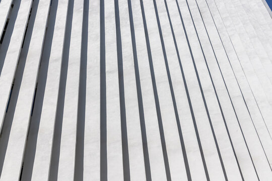 Modern Building Facade with Vertical Fins and Shadows