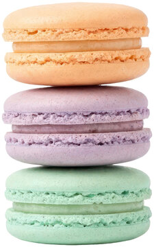 Three colorful french macarons stacked on black background.